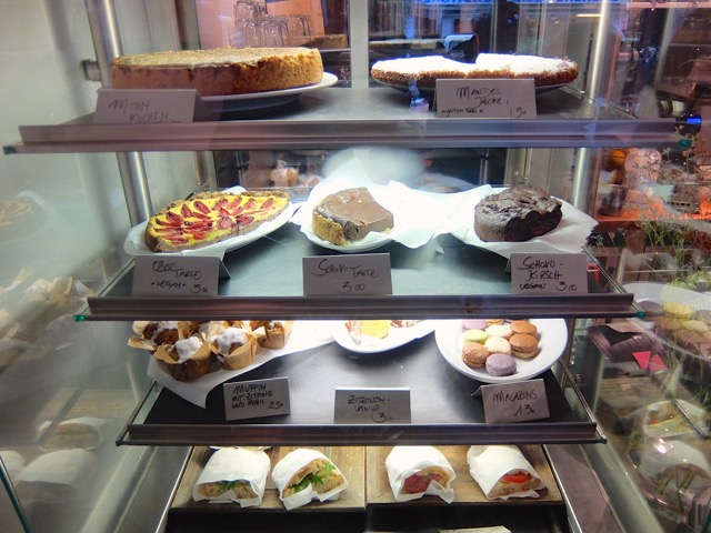 Cakes, macarons, muffins, and sandwiches in the Black Delight display case