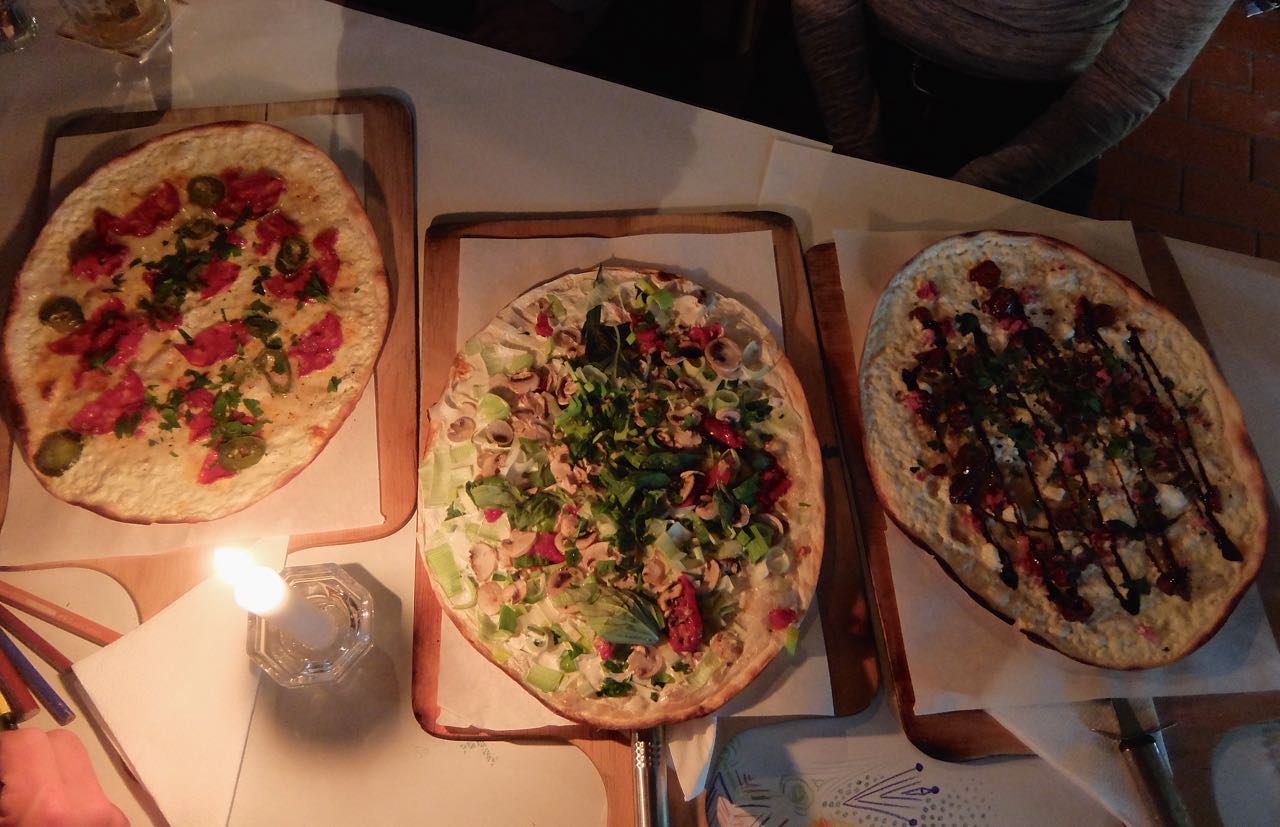 Three varieties of Flammkuchen served on wooden boards at Jimmy Elsass