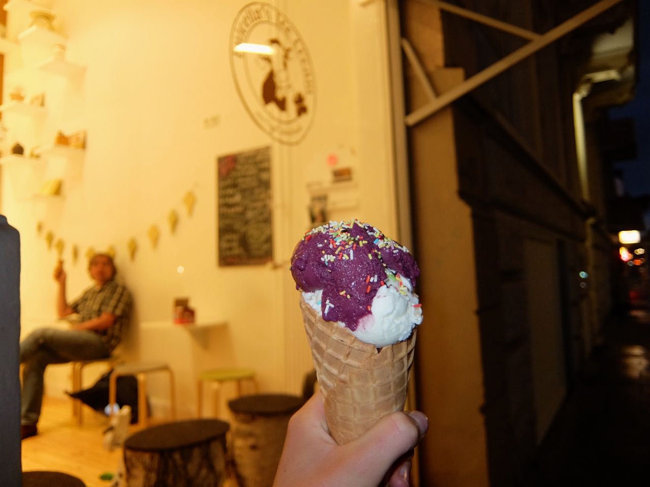 Purple and white Luicella's ice cream cone with colorful sprinkles in St. Pauli