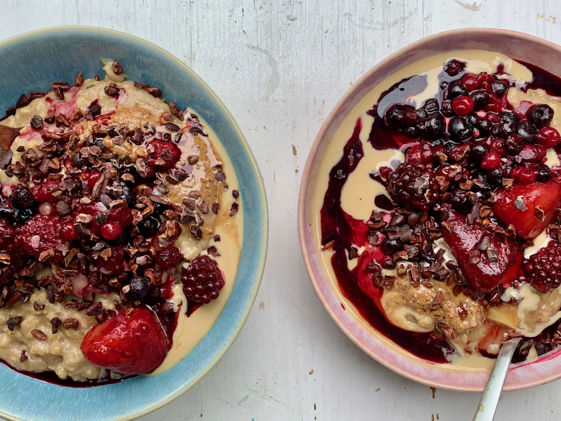 Porridge with Tahini and Nut butter, warm berries and Cacao Nibs