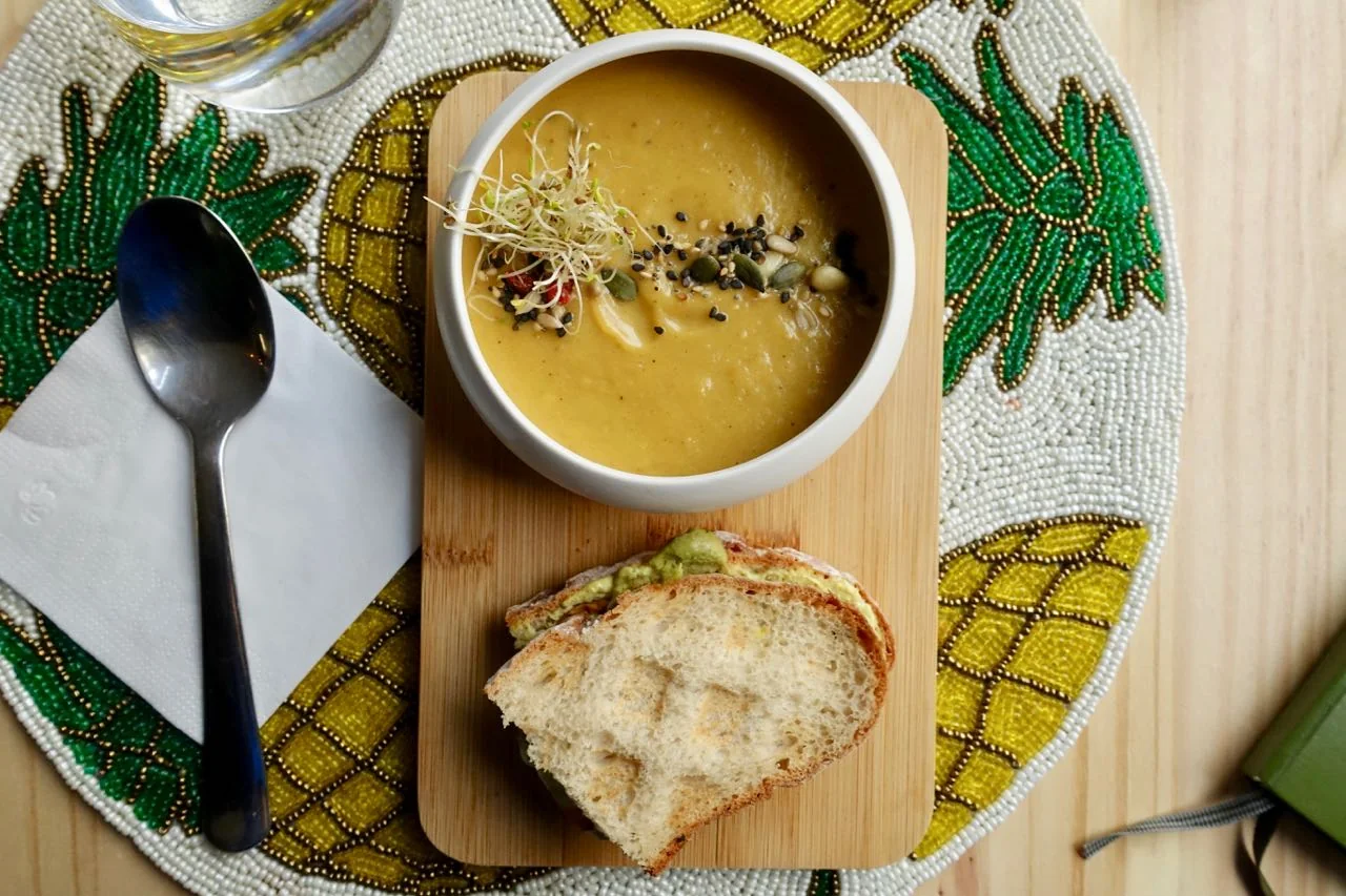 Velouté and Toast: thick pumpkin-coconut soup with seeds, nuts and sprouts with avocado and pumpkin toast on gluten-free bread