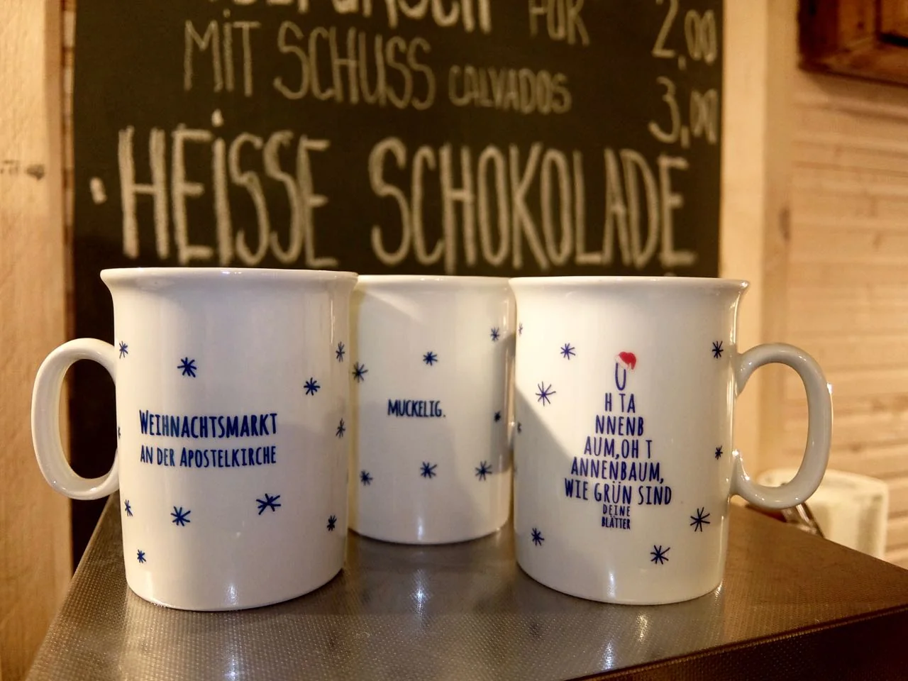 Annual Glühwein cups decorated with new quotes at the Apostelkirche Christmas market