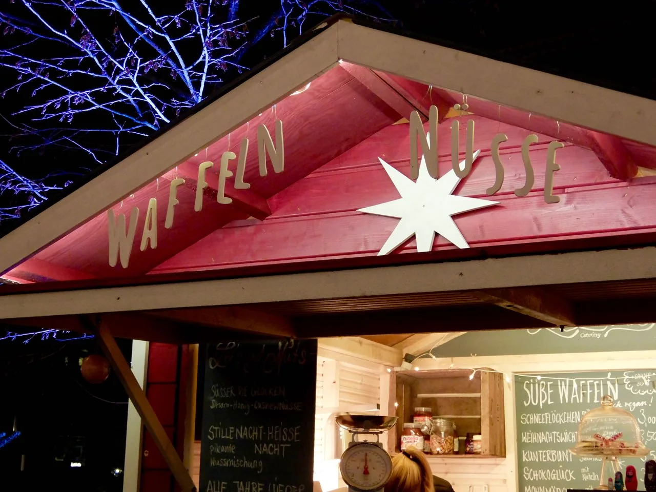 Local stands selling waffles and nuts at the Apostelkirche Christmas market